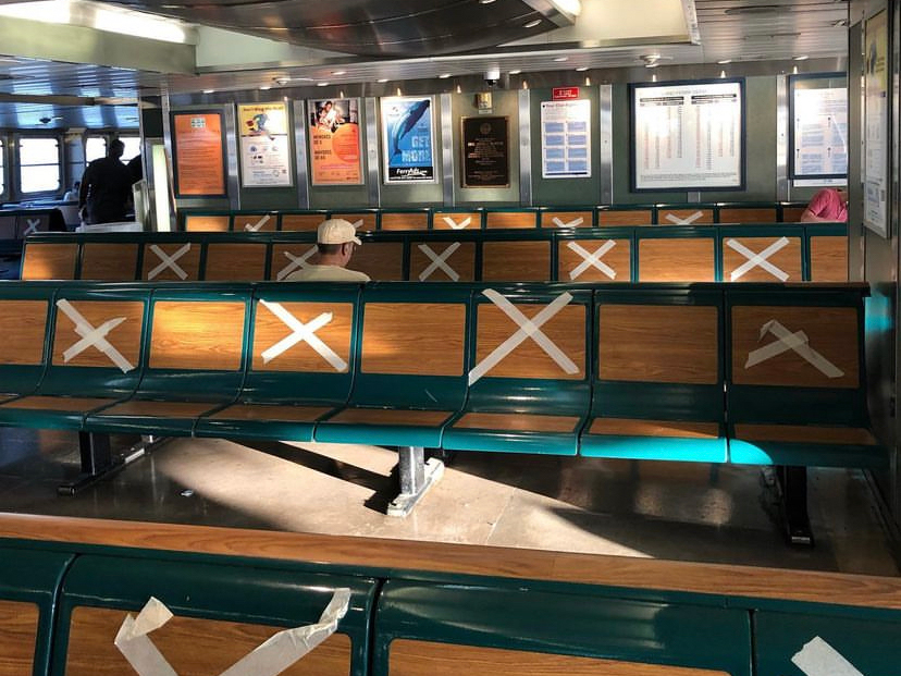 Interior of the Staten Island Ferry with taped x's on every other seat for social distancing purposes
