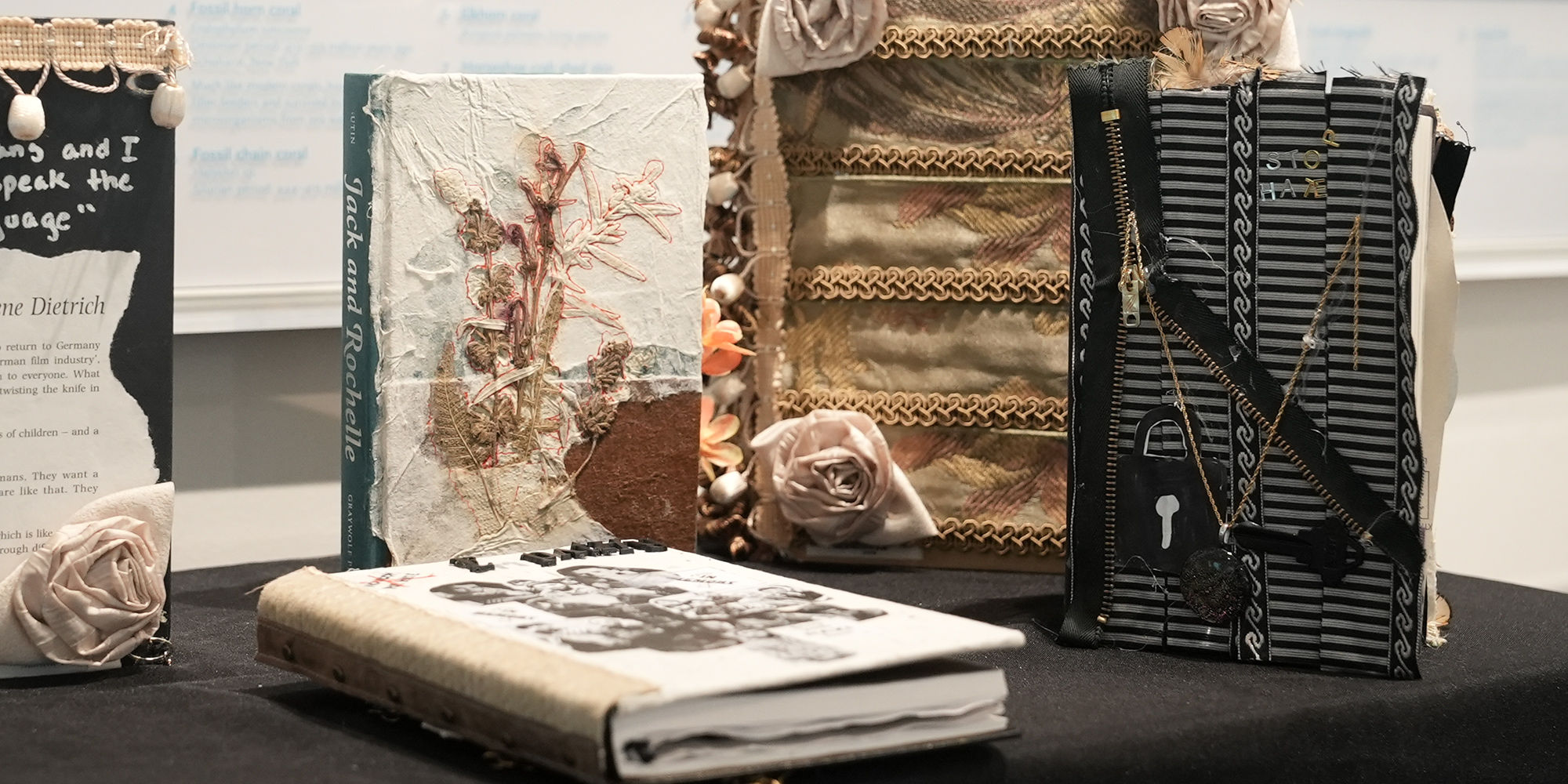 Books that have been artistically altered displayed on a table.